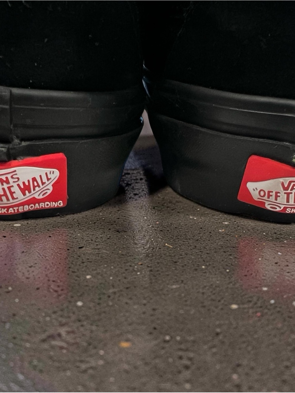 Vans Black Slip-On Sneakers with Red Heel Logo Patch